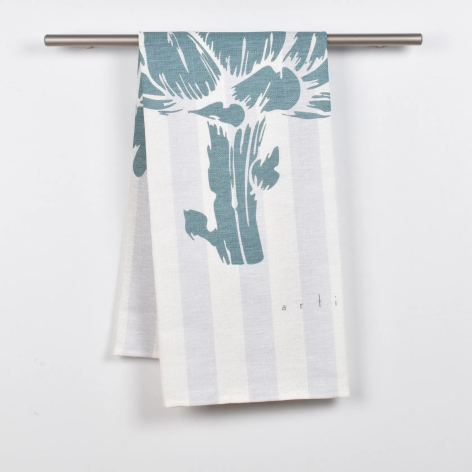 White linen throw with blue-grey botanical print design, draped over silver rail
