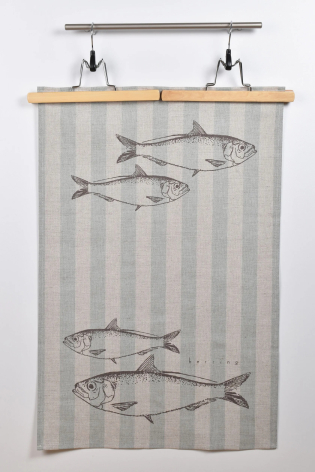 Gray striped linen textile with black fish illustrations displayed on a wooden rod with metal fixtures, front view