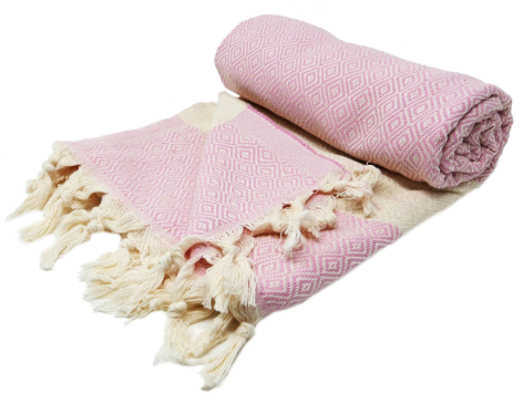 Rolled dusty pink cotton throw with cream fringe trim, front view showing woven texture and tassel details