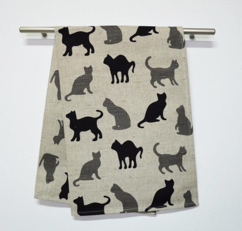 Beige linen drawstring bag with black silhouettes of various dog breeds scattered across front and back