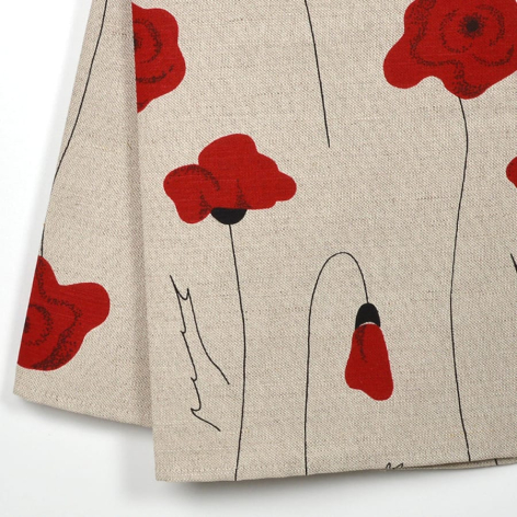 Beige linen textile with scattered red poppy flowers and thin green stems, folded corner view