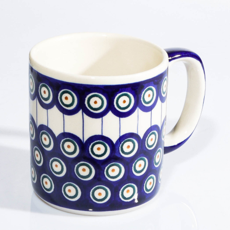 Navy ceramic mug with cream interior and blue handle, decorated with repeating white circle motifs
