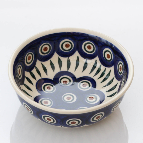 Deep blue ceramic bowl with cream geometric patterns and radiating sun motif, top view