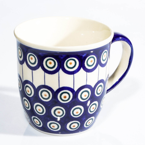 Blue ceramic pitcher with white circular dot pattern and cream interior, front view