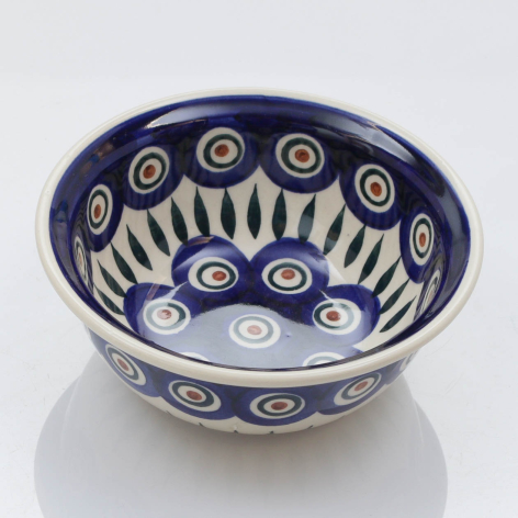 Deep blue ceramic bowl with cream circular patterns and radiating lines, viewed from above at slight angle