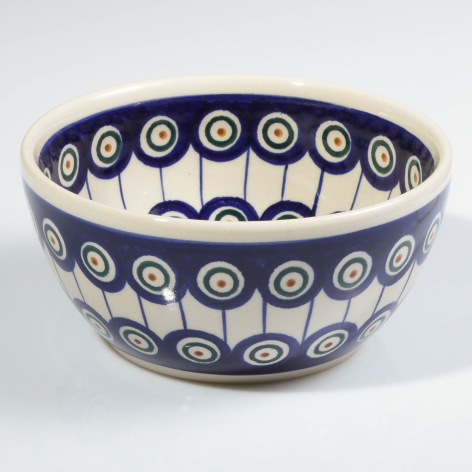 Deep blue ceramic bowl with cream interior, decorated with white circular motifs around exterior and interior rim