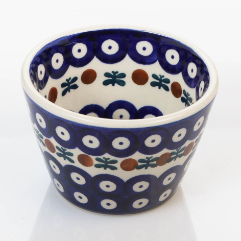 Deep blue ceramic bowl with cream interior, white flowers, and dark blue accents on rim and base