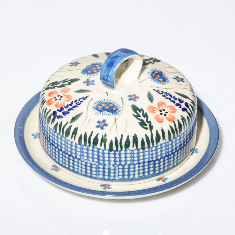Blue and white ceramic food dome with decorative hand-painted floral patterns, shown on matching plate base