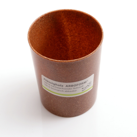 Terracotta leather pencil holder, cylindrical shape with white product label, front view against white background