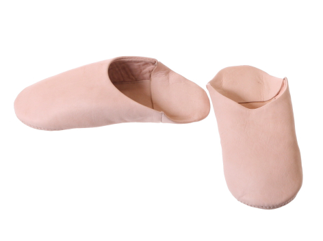 Pair of soft pink leather slippers shown open and closed, displaying interior lining and curved silhouette