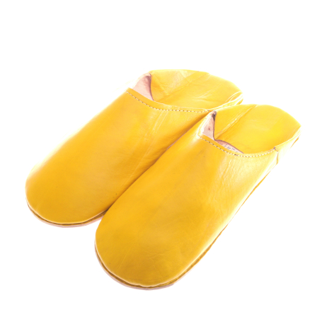 Pair of bright yellow leather slippers with rounded toes and white trim detail, displayed at three-quarter angle