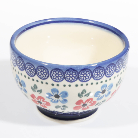 Blue and cream ceramic bowl with hand-painted floral motifs and decorative border, front view