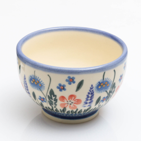 Blue and cream ceramic bowl with hand-painted floral motifs, front view