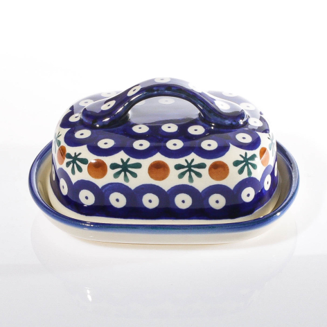 Navy blue ceramic butter dish with hand-painted white dots and floral pattern, domed lid with curved handles
