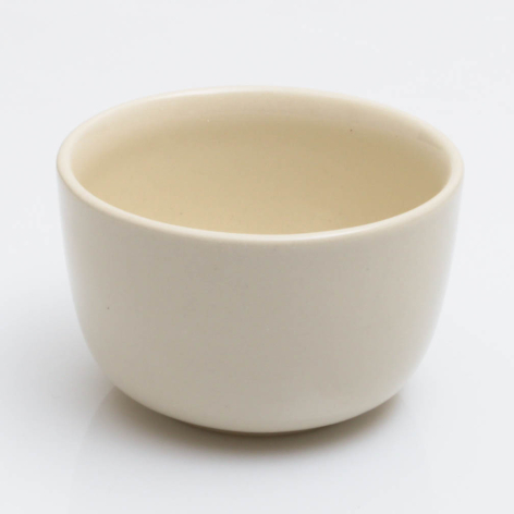 Cream ceramic bowl with rounded sides and smooth glazed finish, front view