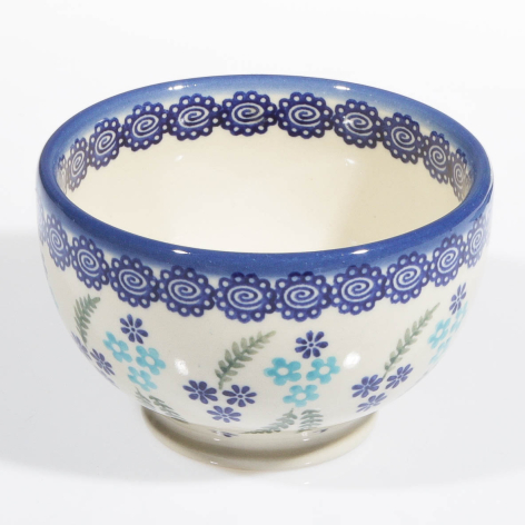 Blue and cream ceramic bowl with floral pattern and decorative blue rim, front view