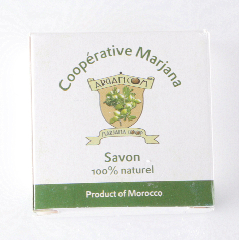 Square soap bar with cream packaging featuring green herbal design and Product of Morocco label