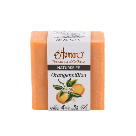 Orange handmade soap bar with cream label featuring natural ingredients and traditional craftsmanship design