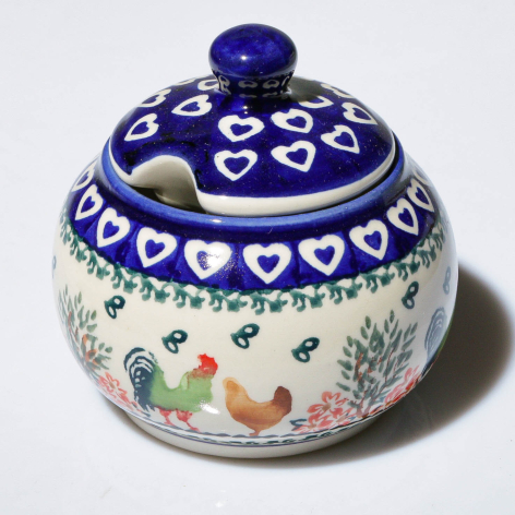 Deep blue ceramic covered bowl with white heart patterns and hand-painted floral base, spherical shape with knob finial