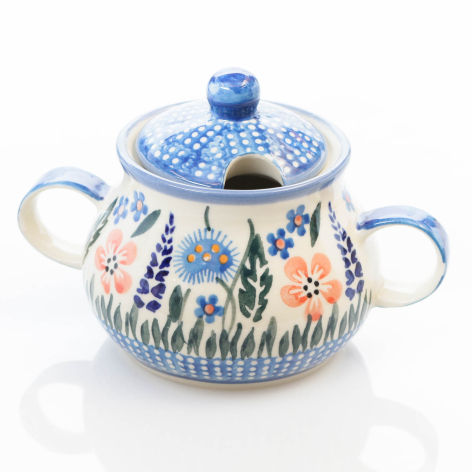 Blue and white ceramic pot with lid, decorated with floral patterns and dual handles, front view