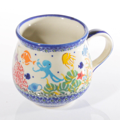 Ceramic mug with blue rim and hand-painted colorful folk art design featuring birds and floral motifs, front view
