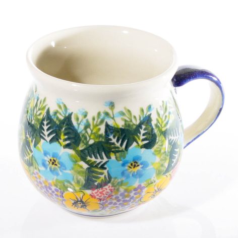Cream ceramic pitcher with blue handle and hand-painted floral pattern featuring blue and yellow flowers