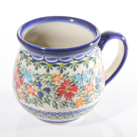 Ceramic pitcher with blue rim and handle, cream body decorated with colorful floral pattern, front view
