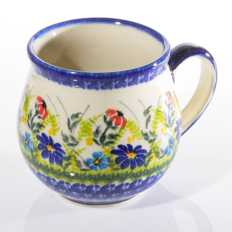 Cream ceramic pitcher with blue rim and handle, decorated with hand-painted wildflower motif in red, yellow, and green