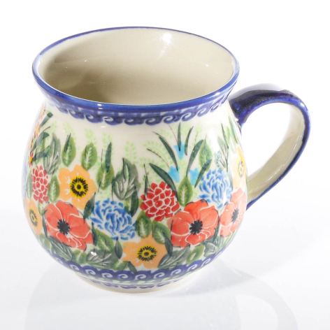 Ceramic pitcher with cream glaze and cobalt blue rim, decorated with painted wildflowers and green foliage