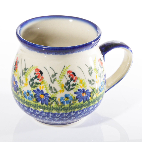 Cream ceramic pitcher with blue rim and handle, decorated with colorful floral motifs and blue geometric border pattern